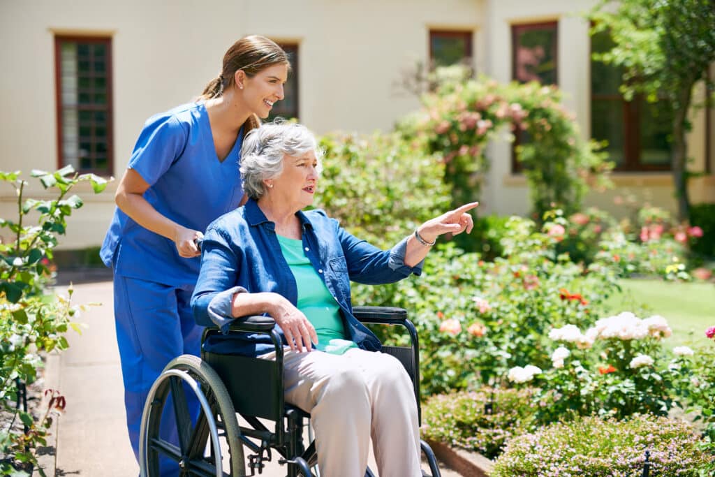Care worker discussing care options with an elderly woman and her family in West Sussex (live in care providers near me)